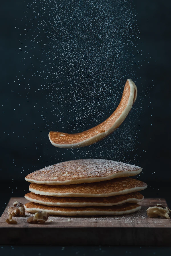 Pila de pancakes con un pancake volando
